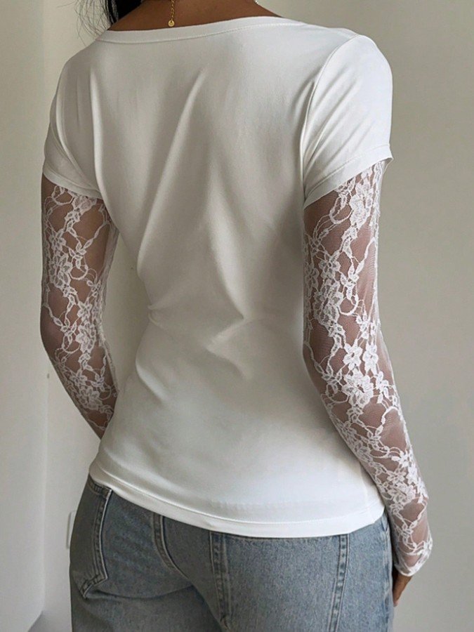 Back view of the white sheer lace long-sleeve top, showing its silhouette and design details.