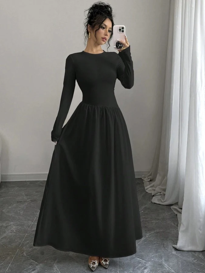 Front view of the black long-sleeve fit-and-flare maxi dress, showing its silhouette and design details.
