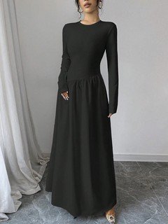 Lifestyle front view of the black long-sleeve fit-and-flare maxi dress, showing its silhouette and design details.