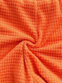 Crochet fabric detail of the orange crochet bandeau top and high-waist shorts set, showing striped crochet bandeau and high-waist shorts.