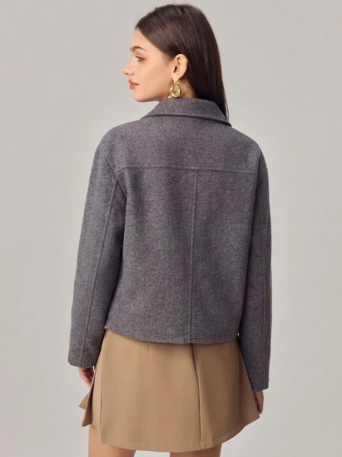 Back view of the gray cropped flap-pocket jacket, showing its silhouette and design details.