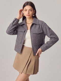 Angled front view of the gray cropped flap-pocket jacket, showing its silhouette and design details.