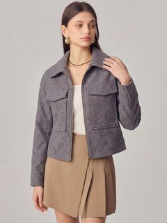 Lifestyle front view of the gray cropped flap-pocket jacket, showing its silhouette and design details.