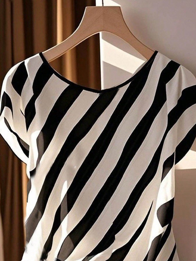 Hanger view of the black and cream diagonal stripe side-tie blouse, showing the overall shape.