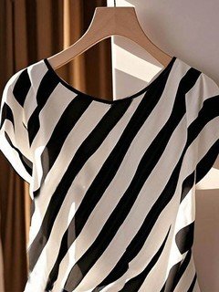 Hanger view of the black and cream diagonal stripe side-tie blouse, showing the overall shape.