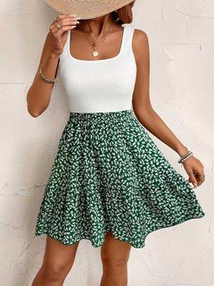 Front close up of the green ditsy floral square-neck sleeveless a-line mini dress, showing square neckline, ditsy floral skirt and flared shape.