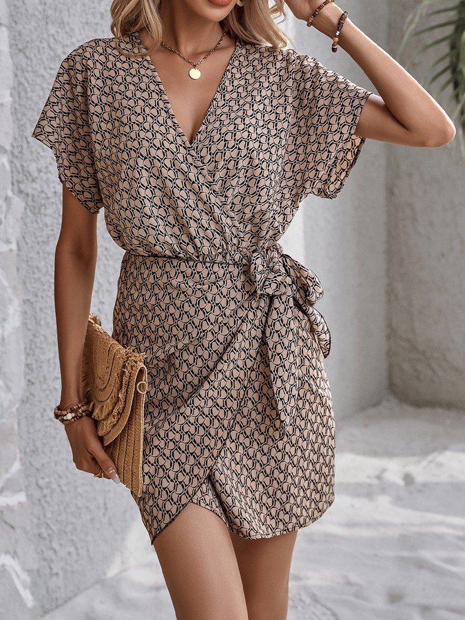 Front view of the brown ditsy print tie-waist wrap dress, showing its silhouette and design details.