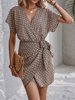 Front view of the brown ditsy print tie-waist wrap dress, showing its silhouette and design details.