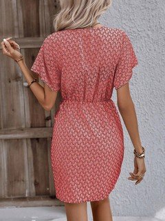 Back view of the coral ditsy print tie-waist wrap dress, showing its silhouette and design details.