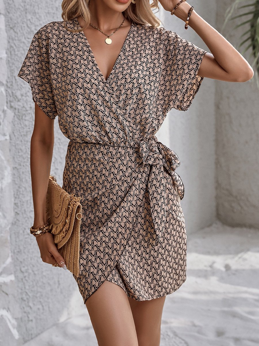 Front view of the brown ditsy print tie-waist wrap dress, showing its silhouette and design details.