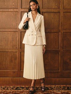 Full-length front view of the cream blazer and pleated midi skirt set, showing its silhouette and design details.