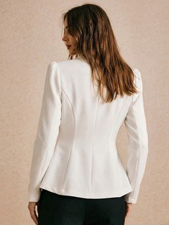 Back view of the ivory double-breasted shawl blazer, showing its silhouette and design details.