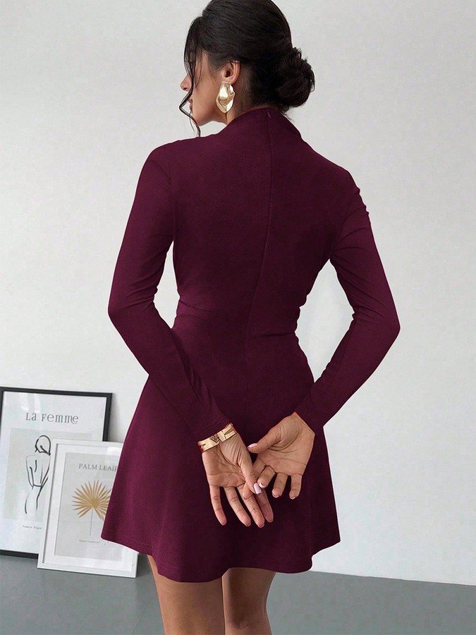 Back view of the burgundy draped mock-neck a-line dress, showing its silhouette and design details.