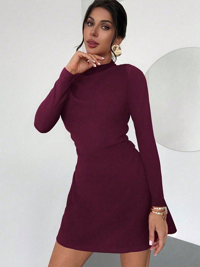 Front view of the burgundy draped mock-neck a-line dress, showing its silhouette and design details.