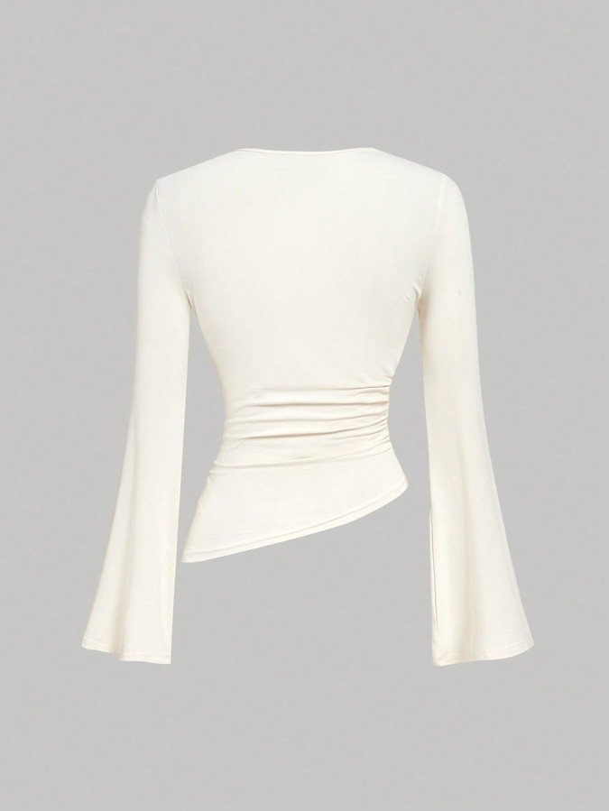 Garment back view of the ivory draped ruched asymmetric flared-sleeve top, showing the silhouette and fit.