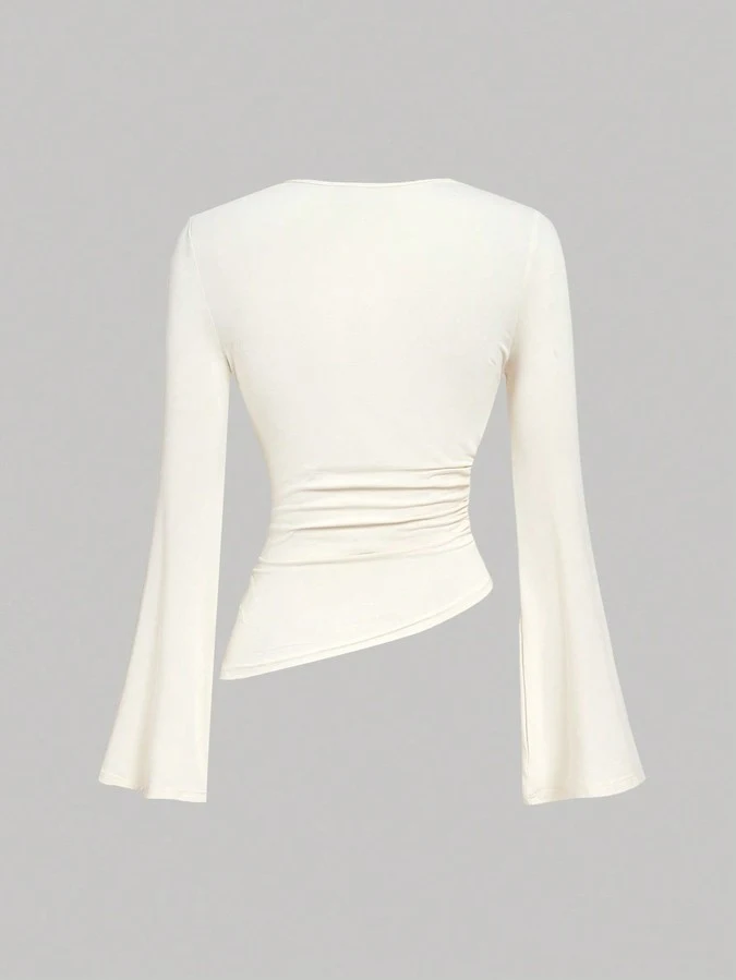 Garment back view of the ivory draped ruched asymmetric flared-sleeve top, showing the silhouette and fit.