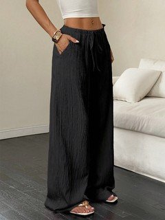 Alternate front view of the black drawstring wide-leg pants, showing its silhouette and design details.