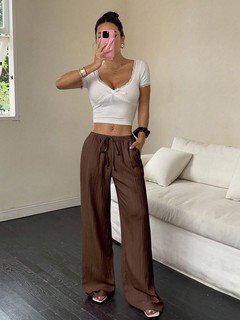 Front view of the brown drawstring wide-leg pants, showing its silhouette and design details.
