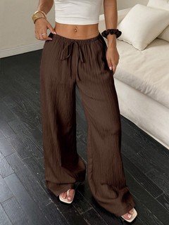 Full-length front view of the brown drawstring wide-leg pants, showing its silhouette and design details.