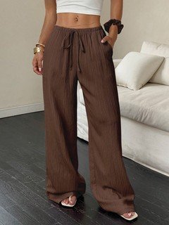 Styled front view of the brown drawstring wide-leg pants, showing its silhouette and design details.