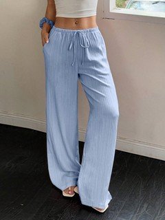 Three-quarter front view of the light blue drawstring wide-leg pants, showing its silhouette and design details.