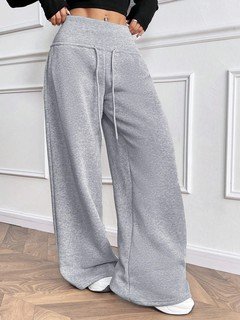 Draping detail of the gray drawstring-waist wide-leg sweatpants, showing elastic drawstring waist and relaxed wide legs.