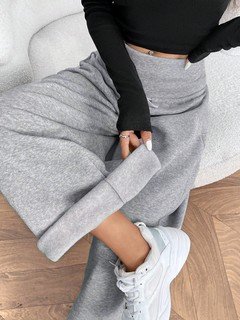 Seated front view of the gray drawstring-waist wide-leg sweatpants, showing the silhouette and fit.