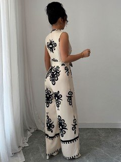 Back view of the ivory embroidered deep-v belted wide-leg jumpsuit, showing the silhouette and fit.