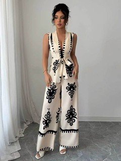Full length front view of the ivory embroidered deep-v belted wide-leg jumpsuit, showing the silhouette and fit.