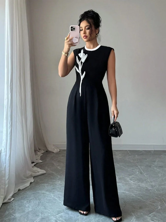 Front view of the black embroidered sleeveless wide-leg jumpsuit, showing the silhouette and fit.