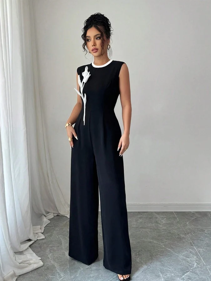 Full length front view of the black embroidered sleeveless wide-leg jumpsuit, showing the silhouette and fit.