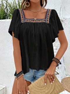 Angled front view of the black embroidered square-neck blouse, showing its silhouette and design details.