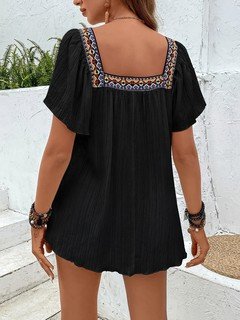 Back view of the black embroidered square-neck blouse, showing its silhouette and design details.