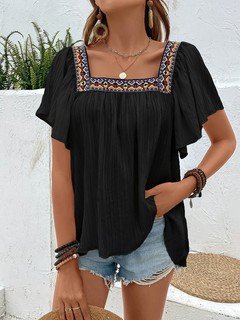 Front view of the black embroidered square-neck blouse, showing its silhouette and design details.