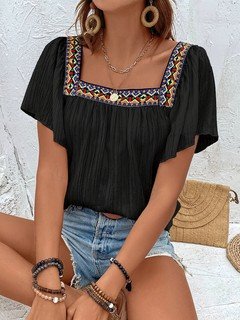 Lifestyle front view of the black embroidered square-neck blouse, showing its silhouette and design details.