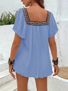 Back view of the blue embroidered square-neck blouse, showing its silhouette and design details.