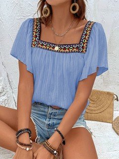 Front view of the blue embroidered square-neck blouse, showing its silhouette and design details.