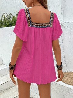 Back view of the fuchsia embroidered square-neck blouse, showing its silhouette and design details.