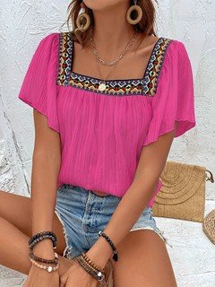Styled front view of the fuchsia embroidered square-neck blouse, showing its silhouette and design details.