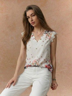 Angled front view of the white floral border sleeveless blouse, showing its silhouette and design details.