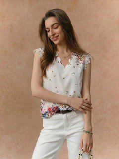 Full-length front view of the white floral border sleeveless blouse, showing its silhouette and design details.