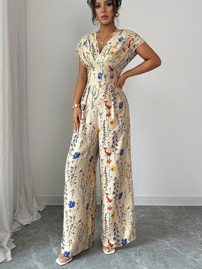 Angled front view of the cream floral wrap-front jumpsuit, showing its silhouette and design details.