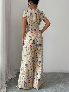 Back view of the cream floral wrap-front jumpsuit, showing its silhouette and design details.