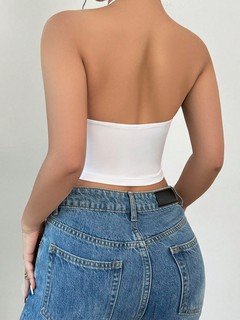 Back view of the white and orange floral cowl-neck halter top, showing its silhouette and design details.