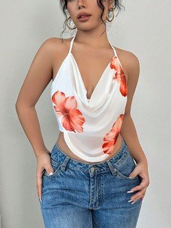 Full-length front view of the white and orange floral cowl-neck halter top, showing its silhouette and design details.