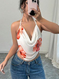 Styled front view of the white and orange floral cowl-neck halter top, showing its silhouette and design details.
