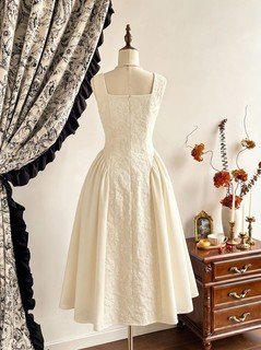 Mannequin back view of the ivory floral-embossed square-neck sleeveless midi dress, showing the silhouette and fit.