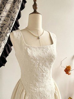 Mannequin bodice view of the ivory floral-embossed square-neck sleeveless midi dress, showing the silhouette and fit.