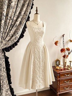 Mannequin front view of the ivory floral-embossed square-neck sleeveless midi dress, showing the silhouette and fit.