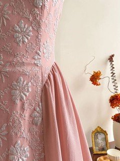 Embossed fabric detail of the pink floral-embossed square-neck sleeveless midi dress, showing raised floral texture, square neckline and midi skirt.